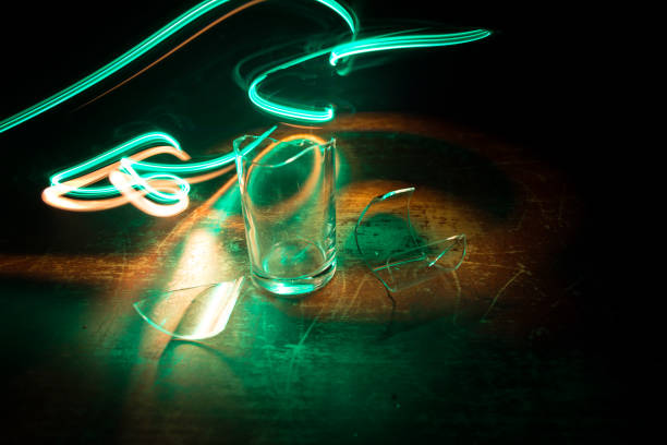 Pint of Ale Beer and shot of Whiskey on Bar with colorful lights in background