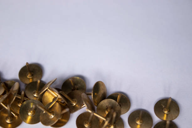 istock golden pins. stationery concept. copy space. isolated 1251952029