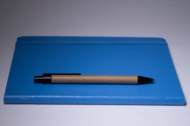 istock blue notebook with a pen on it. stationery concept. copy space. isolated 1251956467