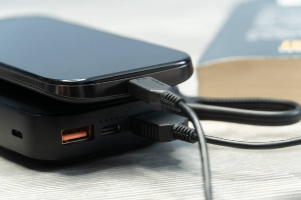 Charging smartphone with a external power energy bank. stock photo