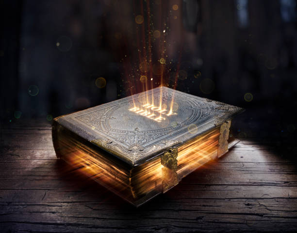 Shining Holy Bible - Ancient Book On Old Table Lights On Holy Bible - Religious Book On Old Table bible stock pictures, royalty-free photos & images