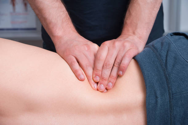 istock Photo of physical therapist making deep or kinesio massage on a mans back 1251957724