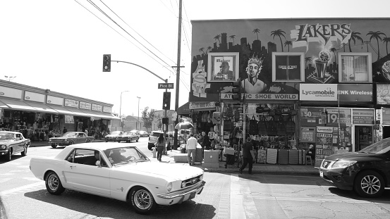 Black and white Los Angeles Fashion District - old american muscle car and graffiti building