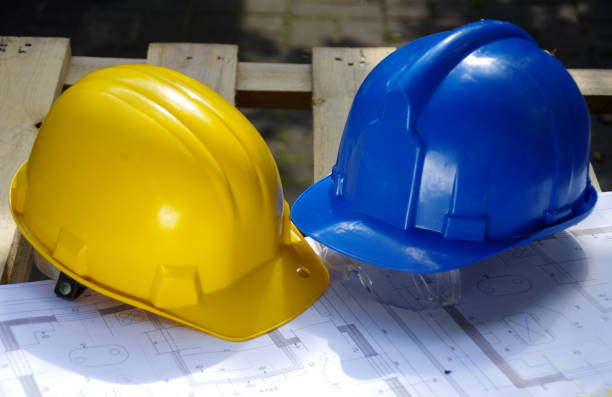 Yellow and blue protective helmet. Personal protective equipment. Safety at the construction site.
