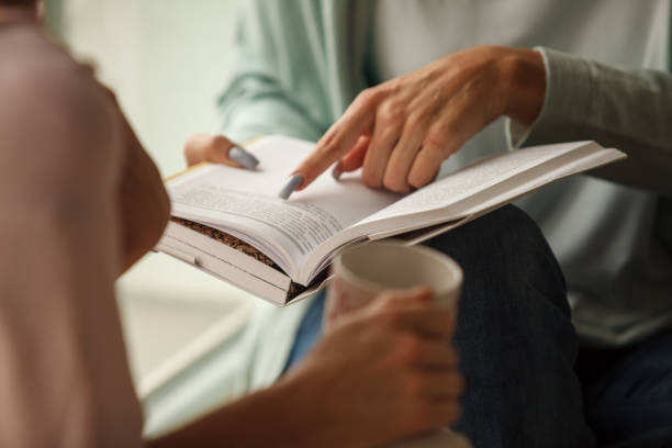 istock Two friends talking about a book they read 1251959412