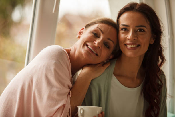 istock Two smiling women looking away and daydreaming 1251959413