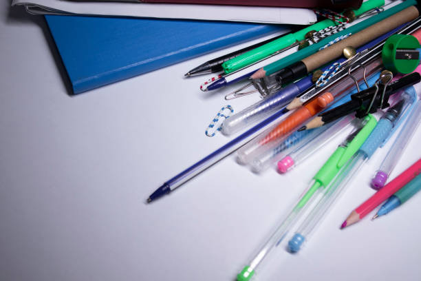istock notebooks, pens, pencils, felt-tip pens, paper clips. stationery concept. copy space. isolated 1251961737