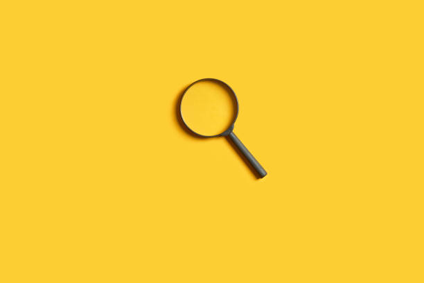 istock detective minimal concept. magnifier over bright yellow background. copy space. 1251965179
