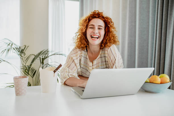 istock Young redhead woman is working from home 1251975766