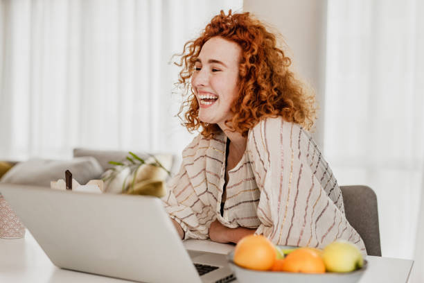 istock Young redhead woman is working from home 1251975858