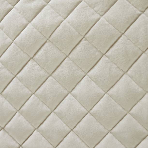 istock Ivory faux velvet diamond quilted bedspread fabric texture 1251976208