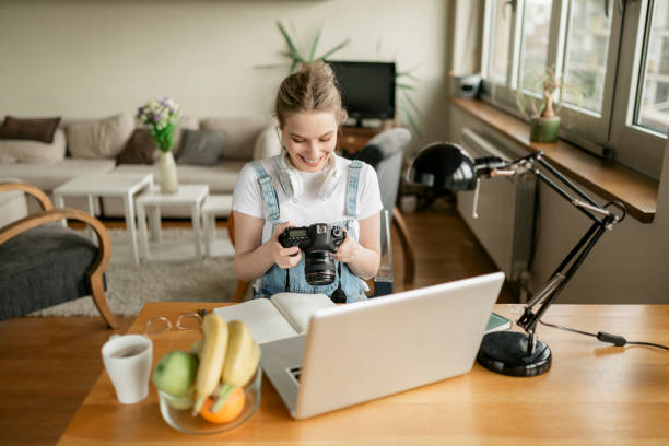 istock Young blonde student photographer working at home 1251994367