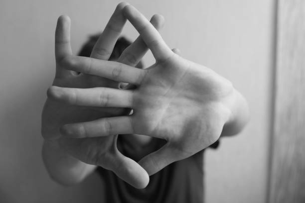 istock Teen boy protects himself with hands 1252007145