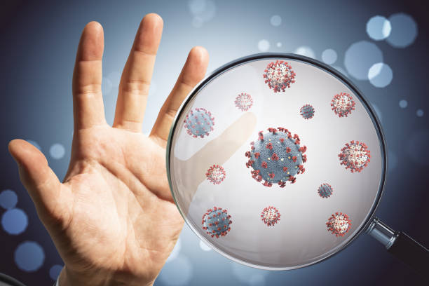 istock Hand and coronavirus 2019-ncov through a magnifying glass. 1252008198