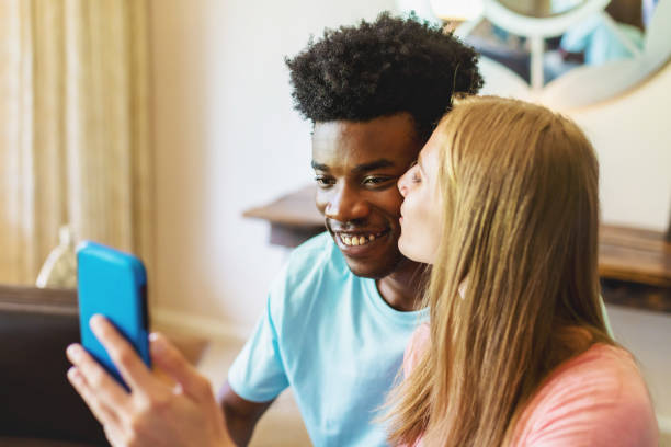 istock Multi Ethnic Heterosexual Generation Z Couple Holding Smart Phone Technology 1252012537