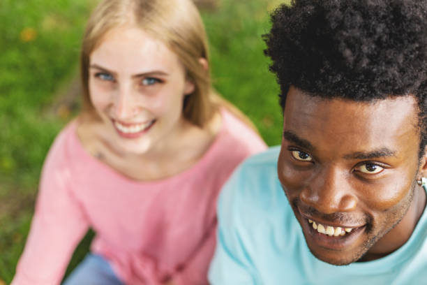 istock Multi Ethnic Heterosexual Generation Z Couple Sitting Outdoors Holding Hands 1252015873