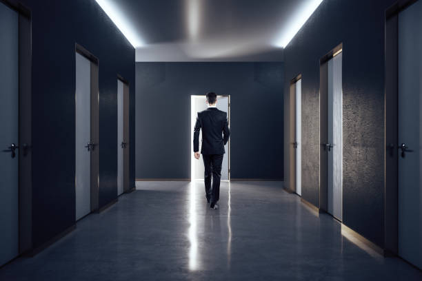istock Businessman in hall interior with closed doors. 1252015934