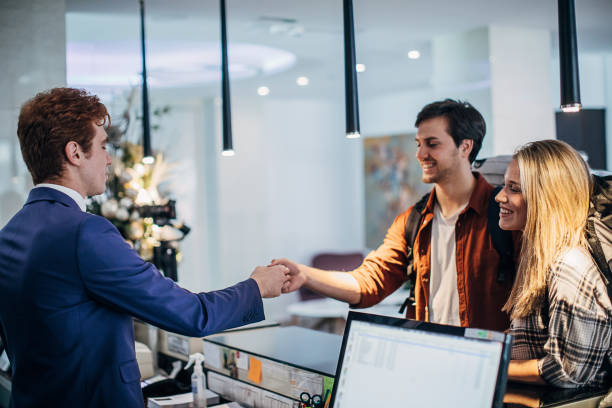 istock Young couple doing the check-in at a hotel reception 1252016078