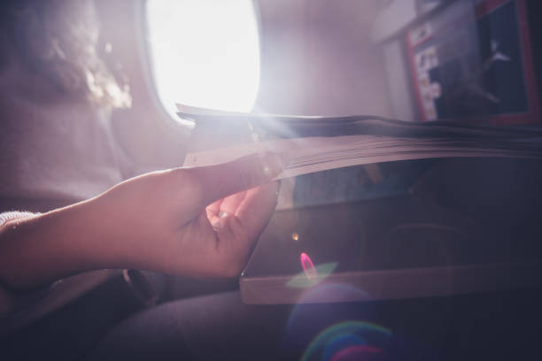 istock Close up of reading newspaper in airplane. 1252016184