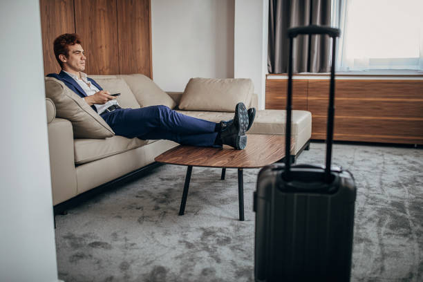 istock Businessman relaxing on sofa in his hotel room 1252021747
