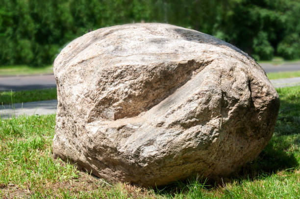 istock A large oval stone lies on the green grass. 1252023844