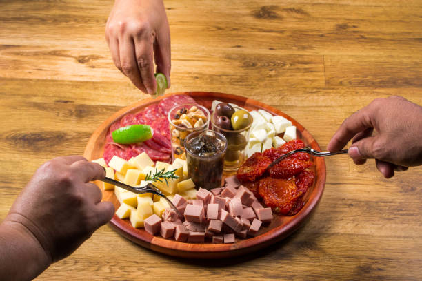 istock people eating board with antipasto. 1252030619