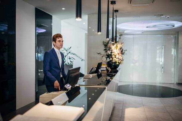istock Male receptionist working in hotel lobby 1252030622