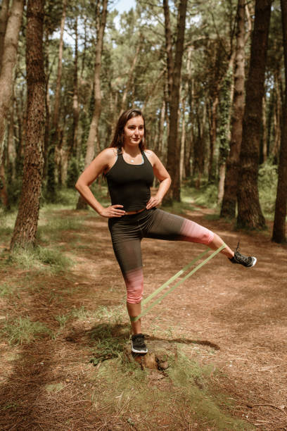 istock Young woman exercising with a resistance band 1252034562