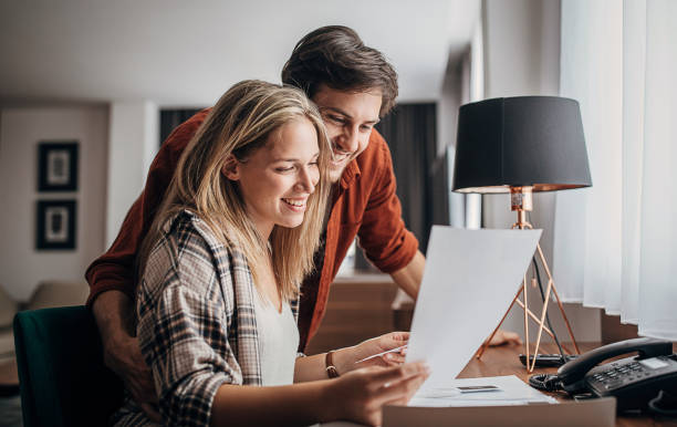 istock Couple looking at brochures in hotel room 1252036244