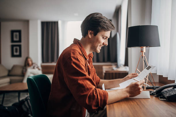 Man looking at brochures in hotel room