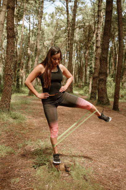 istock Young woman exercising with a resistance band 1252039144