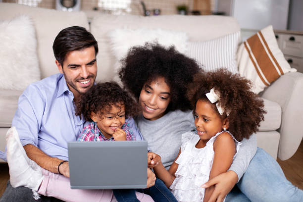 istock Happy family with little kids enjoying using laptop computer together 1252042822