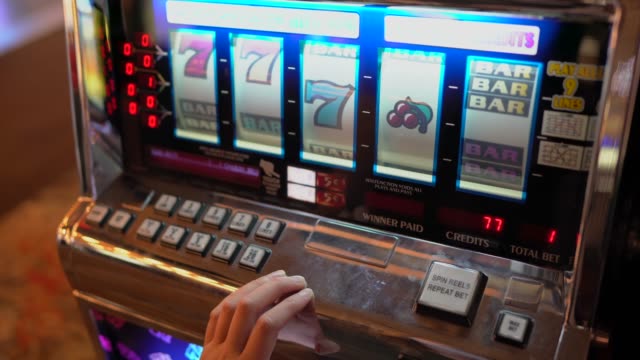 POV closeup hands plays Las Vegas gambling slot machine