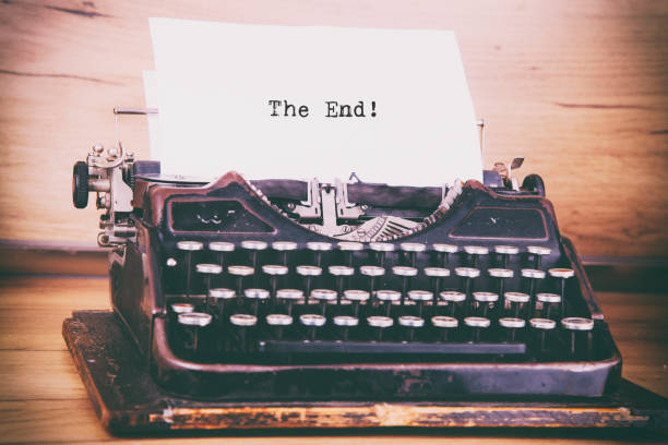 istock Antique typewriter aged textured paper sheet The End 1252058056