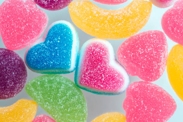 multi-colored gelatin candies in the assortment, fruit sweets in the shape of a heart - raspberry heart shape gelatin dessert valentines day imagens e fotografias de stock