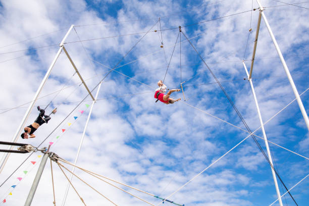 istock Active mature athlete flying to the trapeze instructor in the sky 1252084633
