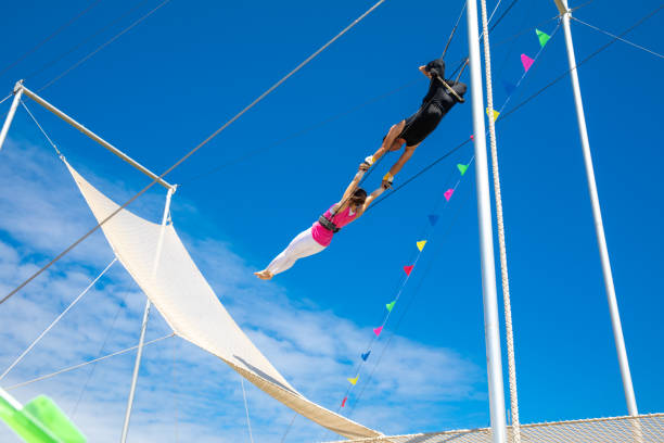 Trapeze artists connecting in the sky