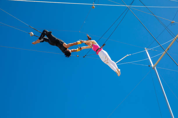 istock Trapeze artists connecting in the sky 1252085164