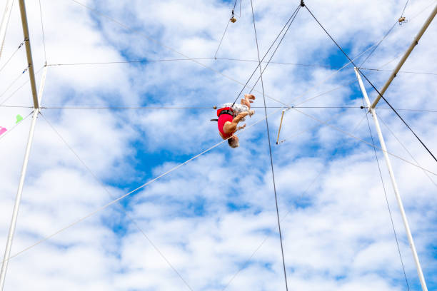 istock Active mature trapeze artist rolling in the sky 1252085671