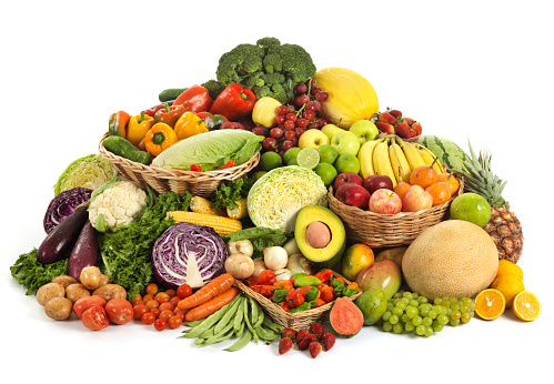 Large and colorful variation of vegetables and fruits on white background (broccoli, melon, bell peppers, lettuce, grapes, apples, limes, watermelon, strawberries, cauliflower, eggplants, onions, potatoes, corn, avocado, tomatoes, mangoes, oranges, bananas, passion fruit, green cabbage, purple cabbage, carrots, green beans, pineapple, guava, chili peppers). Studio isolated.