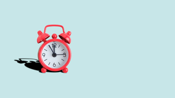 istock Red analog clock on a turquoise background. Copy place. 1252111545