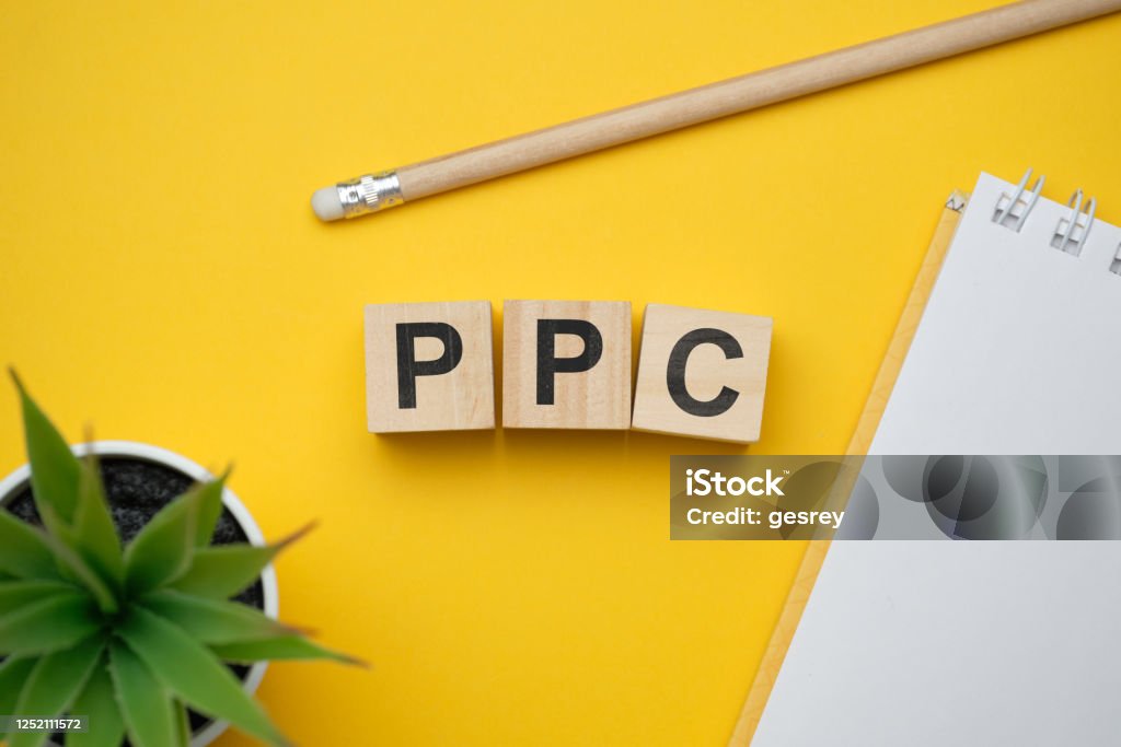 Modern marketing buzzword PPC - Pay per click. Top view on wooden table with blocks. Top view. Modern marketing buzzword PPC - Pay per click. Top view on wooden table with blocks. Top view. Close up. Pay Per Click Stock Photo