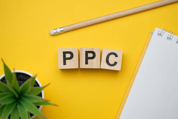 Modern marketing buzzword PPC - Pay per click. Top view on wooden table with blocks. Top view. stock photo
