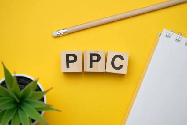 Photo of Modern marketing buzzword PPC - Pay per click. Top view on wooden table with blocks. Top view.