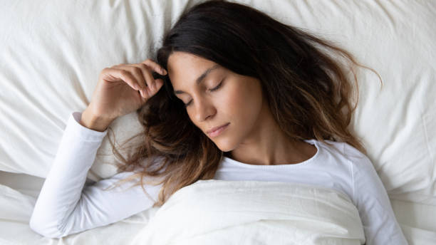 istock Calm young woman relax sleeping in cozy bed 1252119987