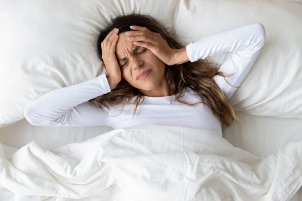 istock Unhappy young woman wake up suffering from headache 1252119997