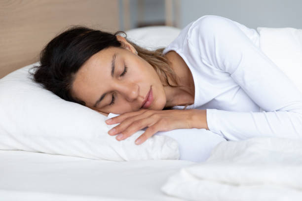 istock Young woman sleeping on white soft pillow 1252120008