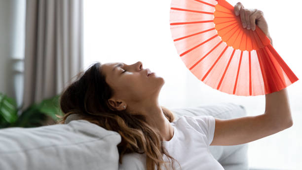 istock Young woman use waver suffering from hot weather 1252120561