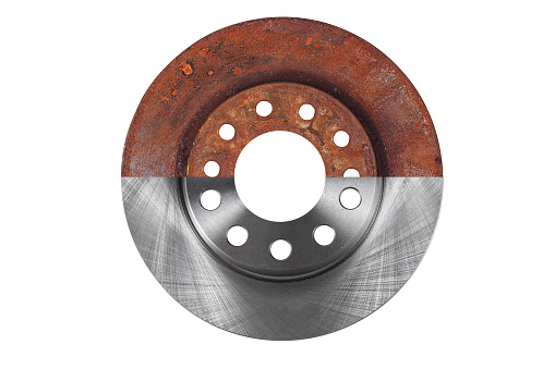 The brake disc new and old are combined in one photograph and isolated on a white background