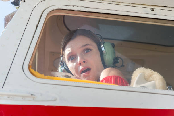 istock Beautiful female pilot and her plane 1252126342
